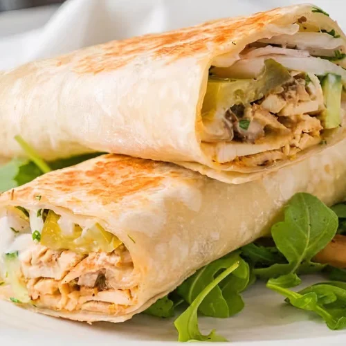 Chicken Shawarma Wrap - Juicy marinated chicken shawarma wrapped in warm pita with hummus, garlic sauce, fresh vegetables, and pickles — a must-try.
