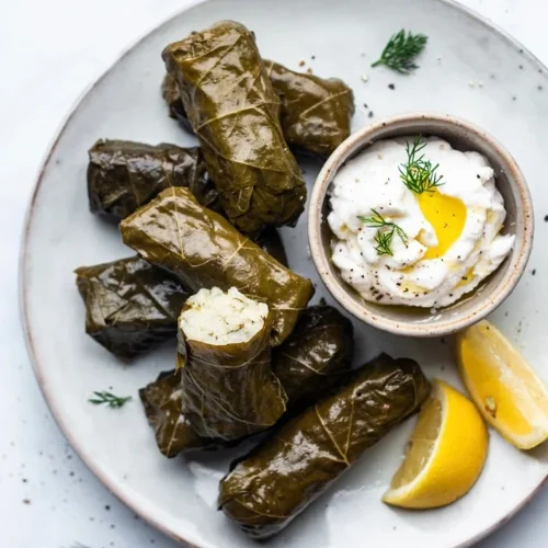 Dolmas - Grape leaves stuffed with seasoned rice and herbs, served with lemon
